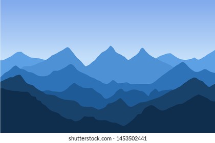 Mountain landscape with blue silhouettes of forest trees mountains and hills. Panoramic mountain view