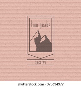 Mountain logo on the cardboard texture. Stock vector.