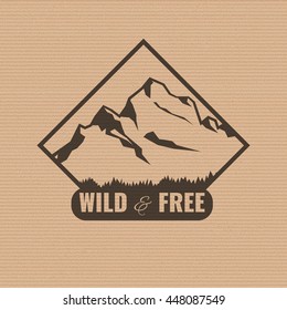 Mountain logo on the cardboard texture. Stock vector.