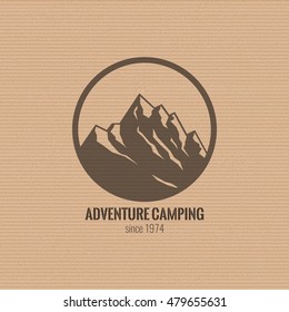 Mountain logo on the cardboard texture background. Stock vector.