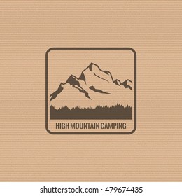 Mountain logo on the cardboard texture background. Stock vector.
