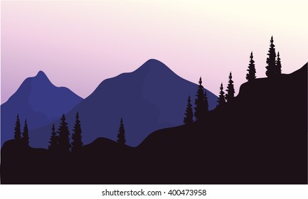 Mountain and spruce of silhouette at the afternoon