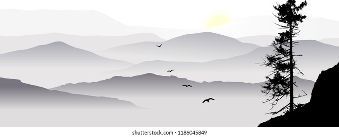 The mountain view with flying birds during a sunrise