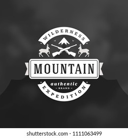 Mountains camping logo emblem vector illustration. Outdoor adventure leisure, Deers and rifles silhouette for shirt, print stamp. Vintage typography badge design.