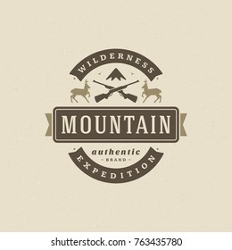 Mountains camping logo emblem vector illustration. Outdoor adventure leisure, Deers and rifles silhouette for shirt, print stamp. Vintage typography badge design.