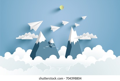 Mountains and clouds and there are paper planes on it with paper and craft art designs