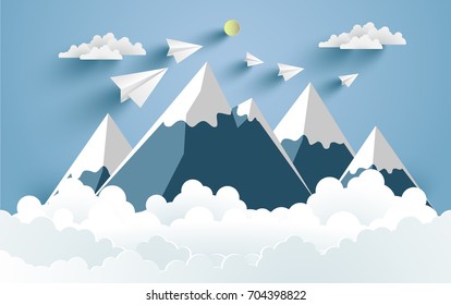 Mountains and clouds and there are paper planes on it with paper and craft art designs