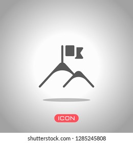 Mountains and flag logo, simple icon. Icon under spotlight. Gray background