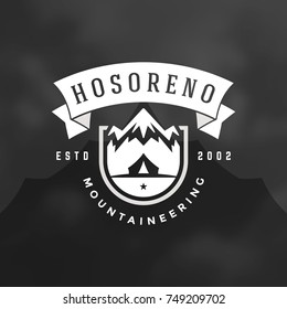 Mountains logo emblem vector illustration. Outdoor adventure camping, mountains and tent silhouettes shirt, print stamp. Vintage typography badge design.