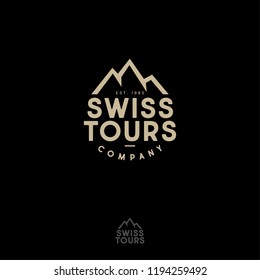 Mountains peaks and letters. Swiss Tours Company logo. Gold emblem for alpinism, ski resort or mountain tourism.