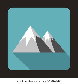 Mountains with snow icon in flat style on a baby blue background