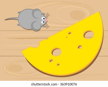 Mouse and cheese on a wooden background