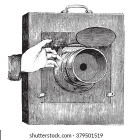 Movable shutter lens for instant photography, vintage engraved illustration. Magasin Pittoresque 1878.
