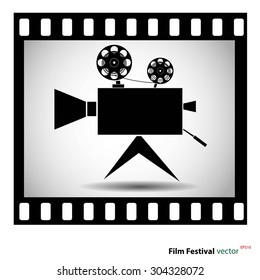 Movie camera at film strip isolated on a white background. stock vector illustration