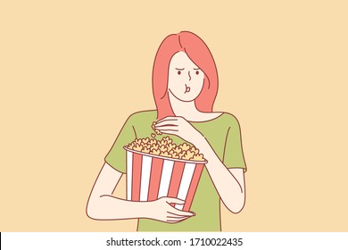 Movie at cinema concept. Young captivated girl or woman teenager with big portion of popcorn watching films. Leisure time illustration in cartoon style.