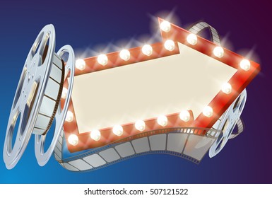 A movie cinema film sign with light bulbs arrow sign and film reel