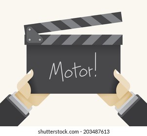 Movie clapper board with Motor text in director's hands. Idea - Filmmaking, Youtube video logging, casting, film industry, production companies, studios, cinematography, screenwriting, pre-production