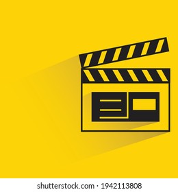 movie clapper board with shadow on yellow background