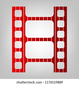 Movie film strip icon. Play button. Vector. Vertically divided icon with colors from reddish gradient in gray background with light in center.