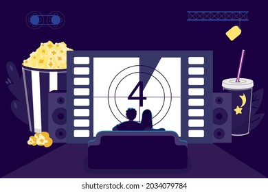 Movie night at home Young couple watching movie or TV on sofa in living room of house Chilling man and women enjoying cinema evening concept Relaxed couple sitting in front of modern television screen