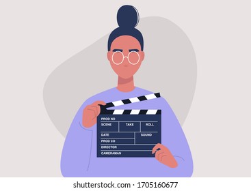 Movie production, young female character holding a clapper board, video industry