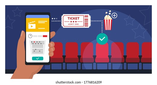 Movie tickets online booking on smartphone app: hand holding a mobile phone and buying a ticket, cinema seats in the background