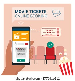 Movie tickets online booking on smartphone app: hand holding a mobile phone and buying a ticket, cinema seats in the background