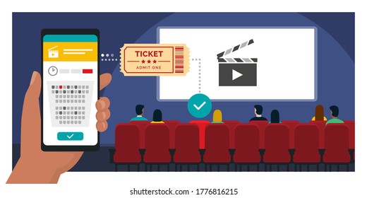 Movie tickets online booking on smartphone app: hand holding a mobile phone and buying a ticket, people sitting in the movie theater in the background