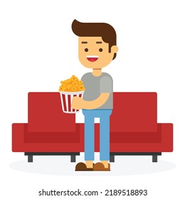 Movie time. Young man at the cinema with popcorn