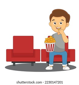 Movie time. Young man at the cinema with popcorn