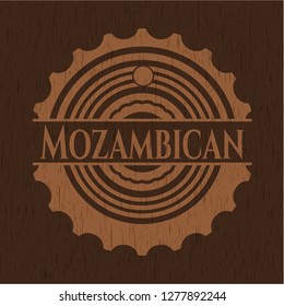 Mozambican badge with wooden background