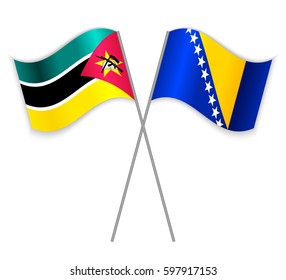 Mozambican and Bosnian crossed flags. Mozambique combined with Bosnia and Herzegovina isolated on white. Language learning, international business or travel concept.