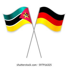 Mozambican and German crossed flags. Mozambique combined with Germany isolated on white. Language learning, international business or travel concept.