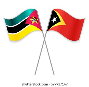 Mozambican and Timorese crossed flags. Mozambique combined with East Timor isolated on white. Language learning, international business or travel concept.