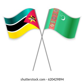 Mozambican and Turkmen crossed flags. Mozambique combined with Turkmenistan isolated on white. Language learning, international business or travel concept.