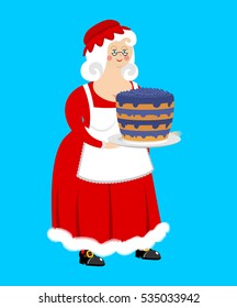 Mrs. Claus and blueberry cake. Wife of Santa and dessert. Christmas woman in red dress and white apron
