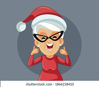 Mrs. Claus Holding Thumbs Up Celebrating Christmas. Senior lady celebrating winter holidays keeping optimistic
