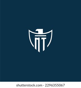 MT initial monogram logo for shield with eagle image vector design
