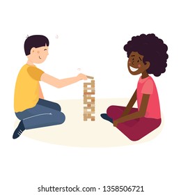 Multi cultural friendship and teenager friends pastime concept. Two children - asian boy and african american girl having fun with playing wood tower game sitting on floor. 