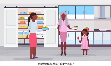 multi generation family preparing food together african american  