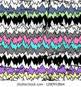 Multicolor pattern with zigzag lines. Vector seamless bold print with chevron ornament in the boho style.