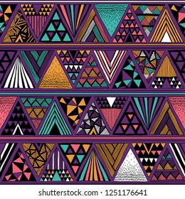 Multicolor tribal vector seamless pattern with doodle triangles. Aztec fancy abstract geometric art print.  Hand drawn. Ethnic background. Wallpaper, cloth design, fabric, tissue, textile template.