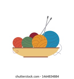 Multicolored balls of yarn lie in a bowl with knitting needles Vector illustration