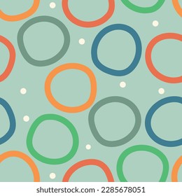 círculos multicolores sobre un fondo verde. Fondo vectorial sin fisuras, diseño atractivo, garabatos infantiles adecuados para el fondo general.