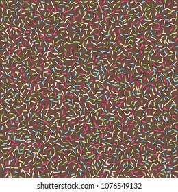 Multicolored confetti on a brown background. Sprinkle for cakes and muffins.