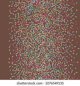 Multicolored confetti on a brown background. Sprinkle for cakes and muffins.
