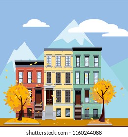 Multicolored multi-party houses at the foot of the mountains. Flat cartoon vector illustration of Autumn city landscape. Three-four-story colorful houses under clouds and blue sky. Street cityscape.