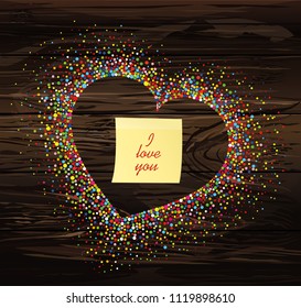 Multicolored rainbow confetti in the shape of a heart. Empty Yellow sheet of paper for notes. Sticker.Vector on wooden background. Love. Postcard or invitation for a holiday. Valentine's Day.