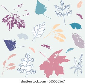 Multicolored seamless pattern with leaves and seeds of maple and leaves of poplar, ash tree and oak; both drawings and stylized as stamp or imprint; rustic or boho style