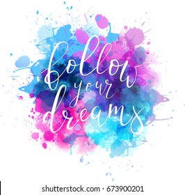 Multicolored splash watercolor blot with handwritten calligraphy text "Follow your dreams"